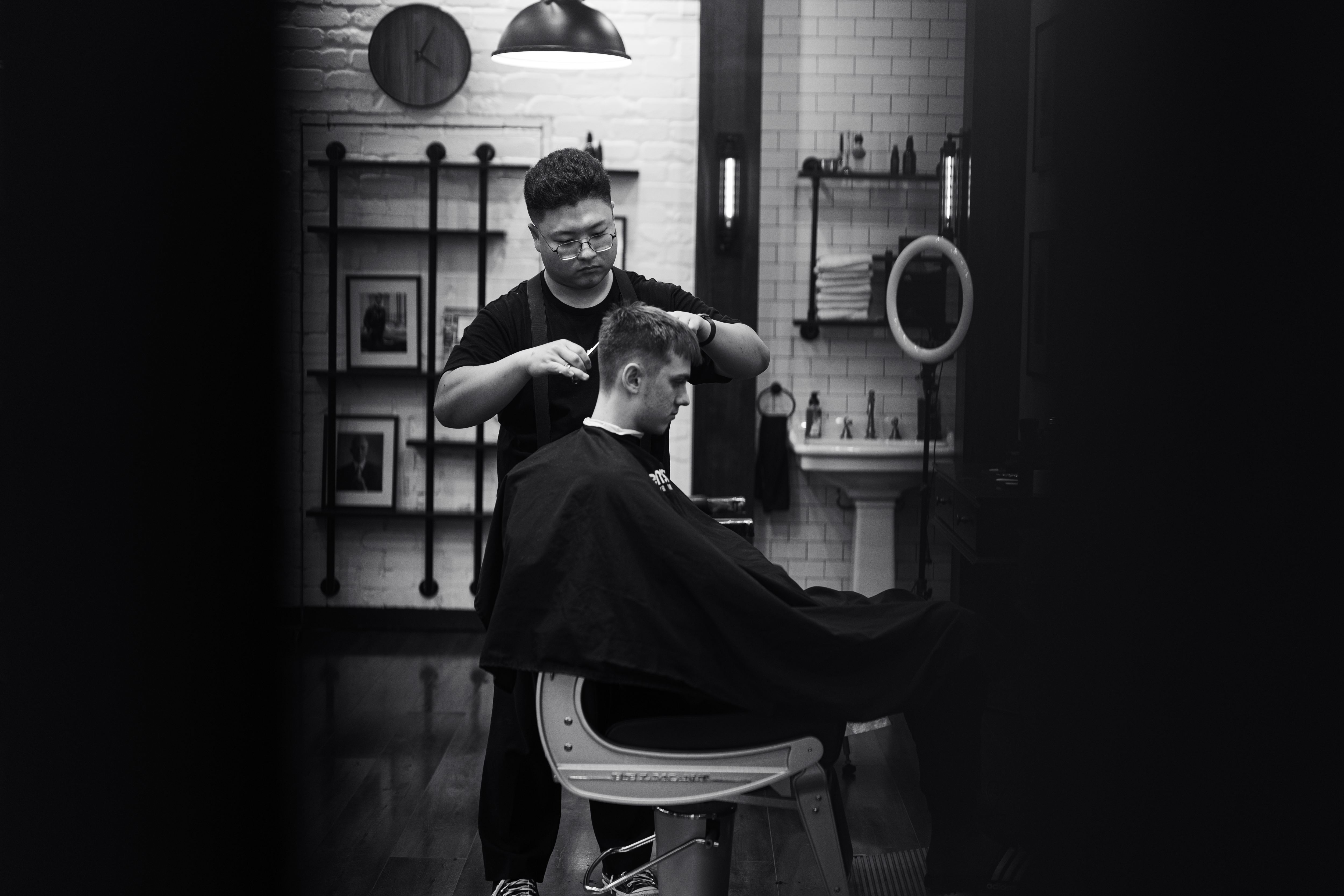 Barber working on client's hair