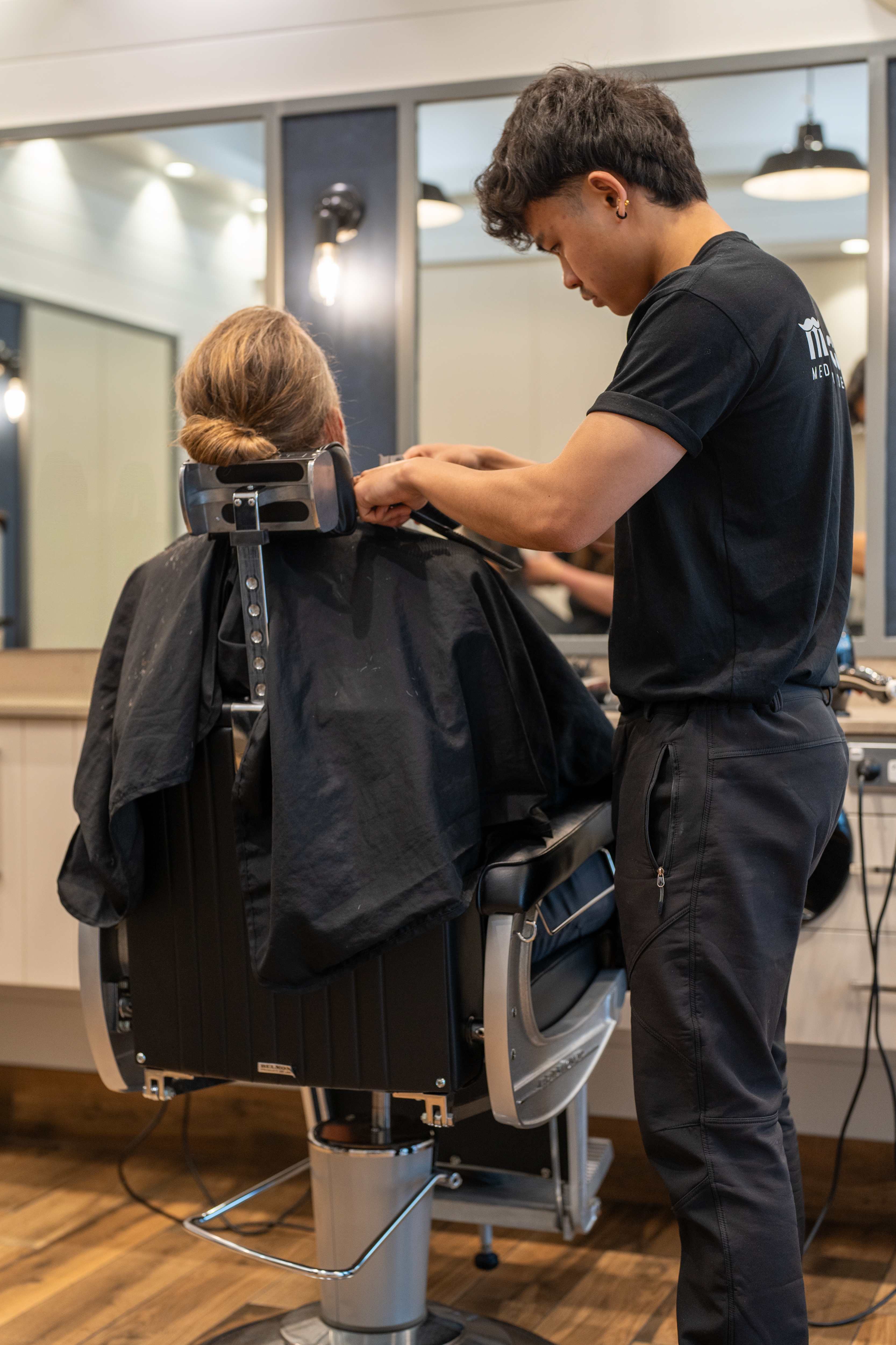 Men's Cuts barber performing a precision haircut