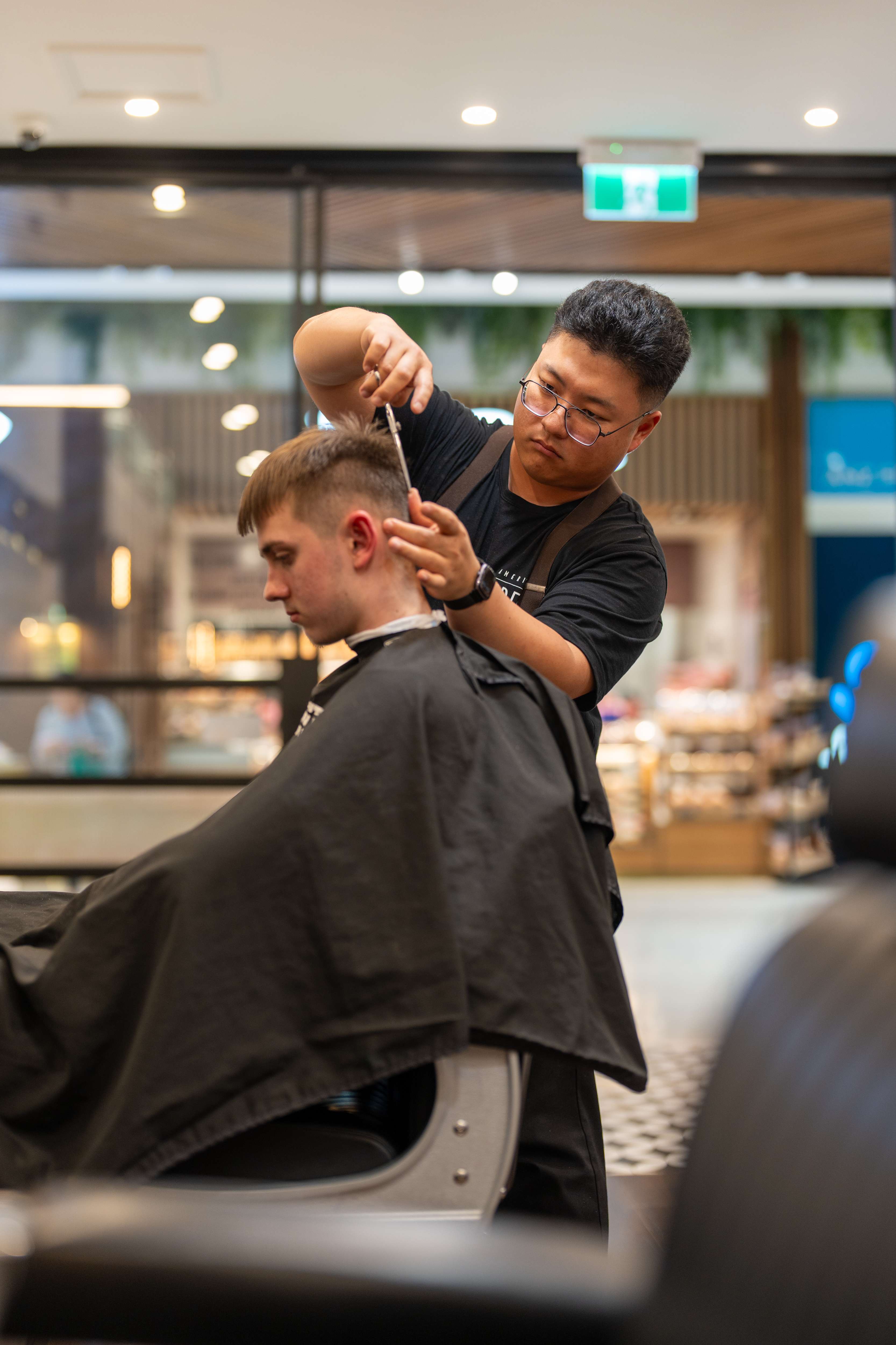 Barber styling client's hair